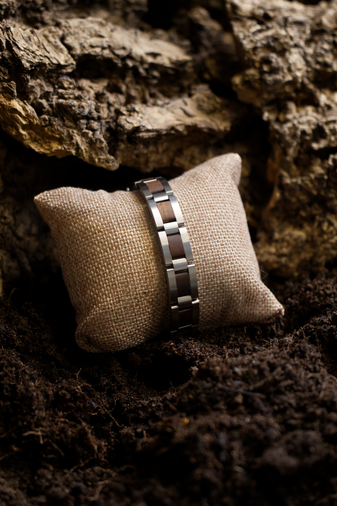 Algarve walnut and stainless steel bracelet on a cushion, side view - The Wood Look
