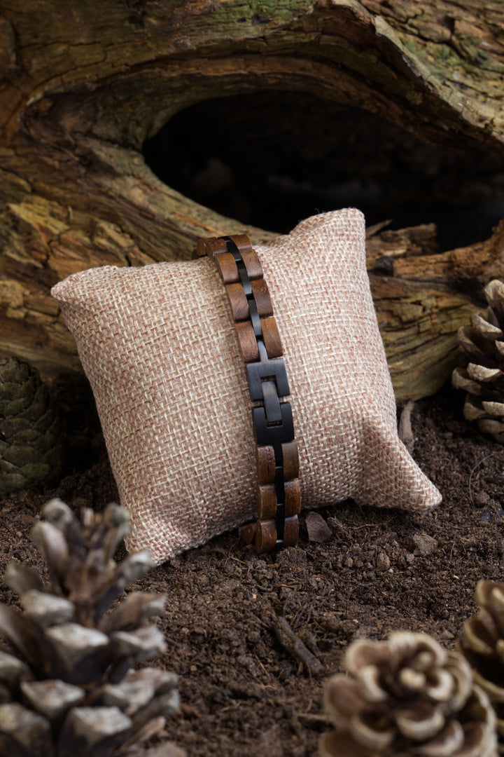 Aspen walnut and black stainless steel bracelet on a hessian cushion - The Wood Look