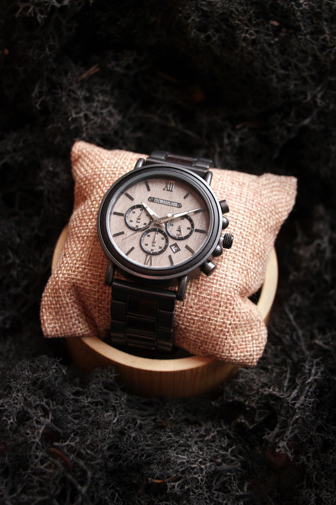 Austin gunmetal steel and ebony watch on a cushion and wooden stand - The Wood Look