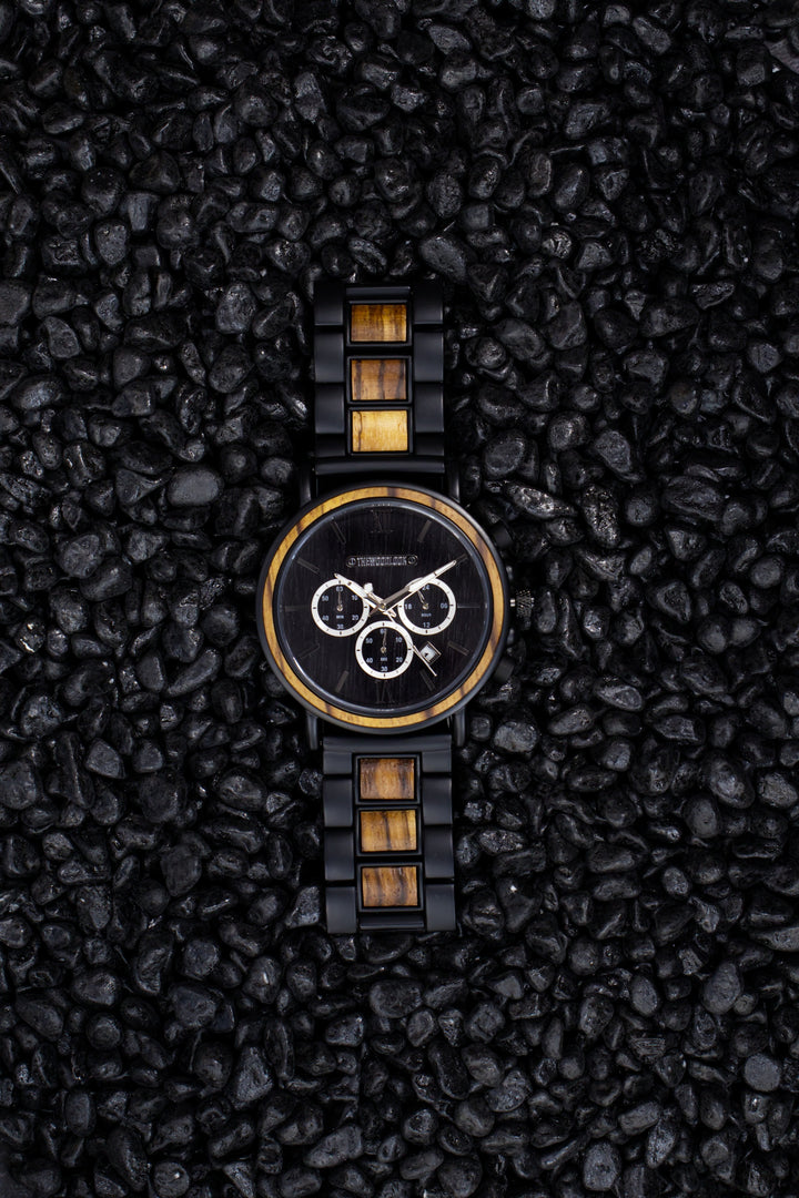 Boston zebrawood chronograph watch from above on black stones - The Wood Look