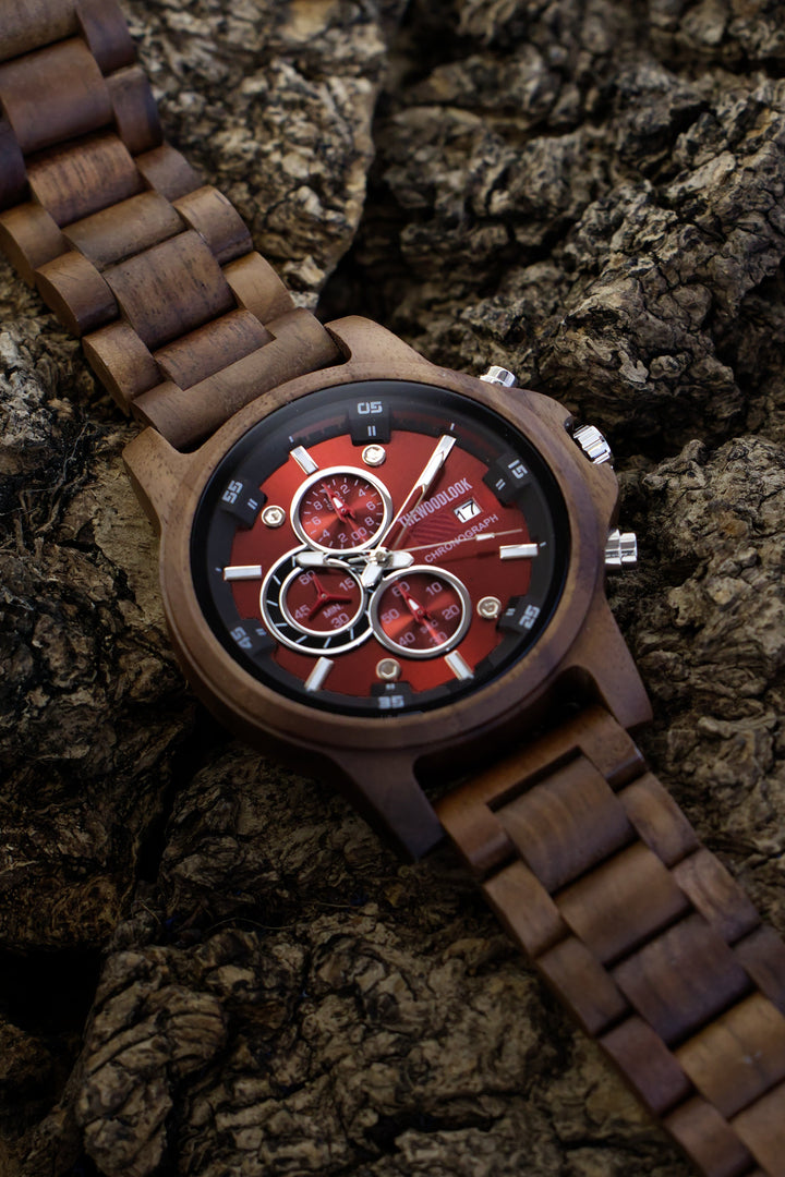 Edinburgh walnut chronograph wooden watch with a red dial resting on bark - The Wood Look