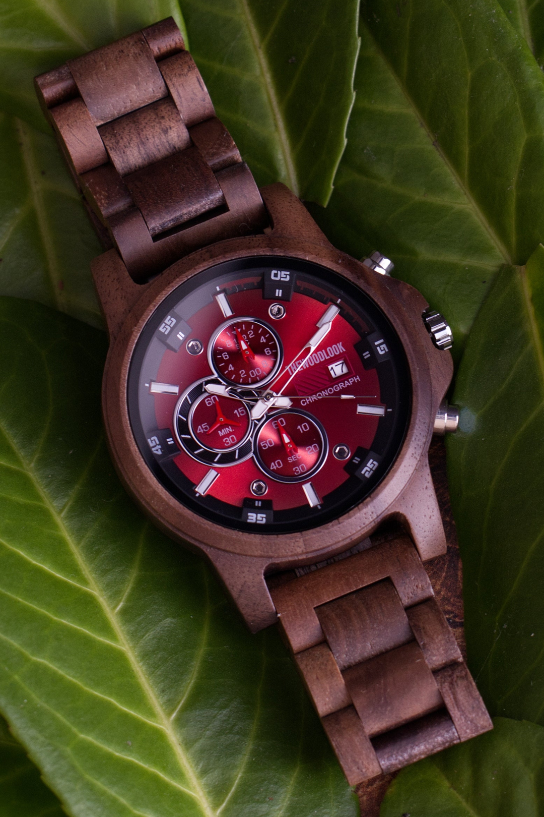 Edinburgh walnut wooden watch with a red chronograph dial on a green leaf - The Wood Look