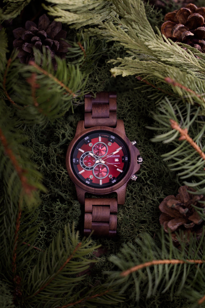 Edinburgh wooden chronograph watch with a red dial among pine branches and pine cones - The Wood Look