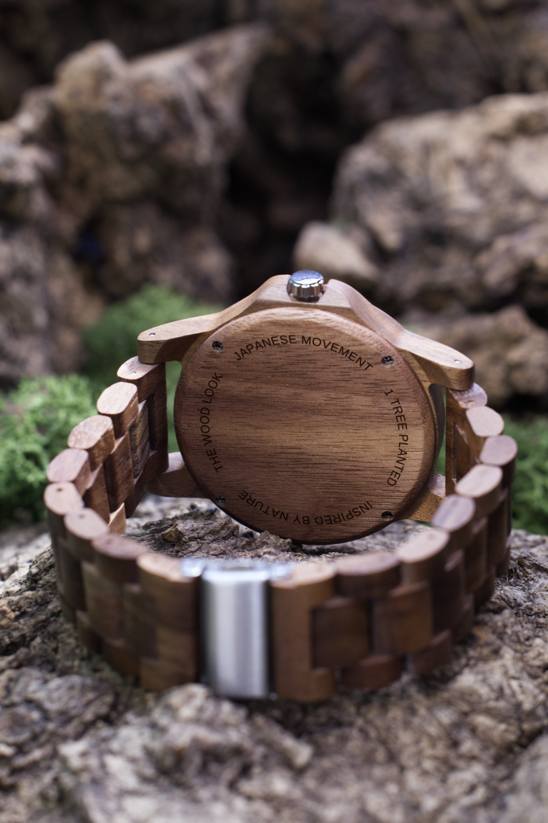 Back of the Goa walnut watch showing the wooden caseback and walnut links, resting on a rock - The Wood Look