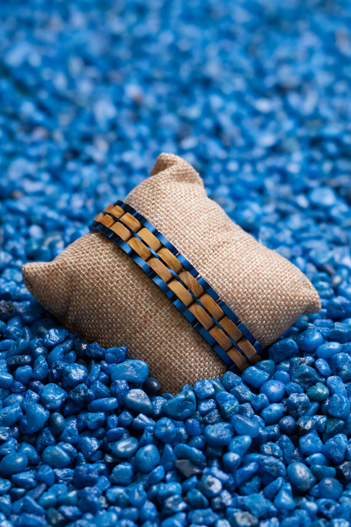 Jodhpur olive wood and blue brushed steel bracelet on a hessian cushion - The Wood Look