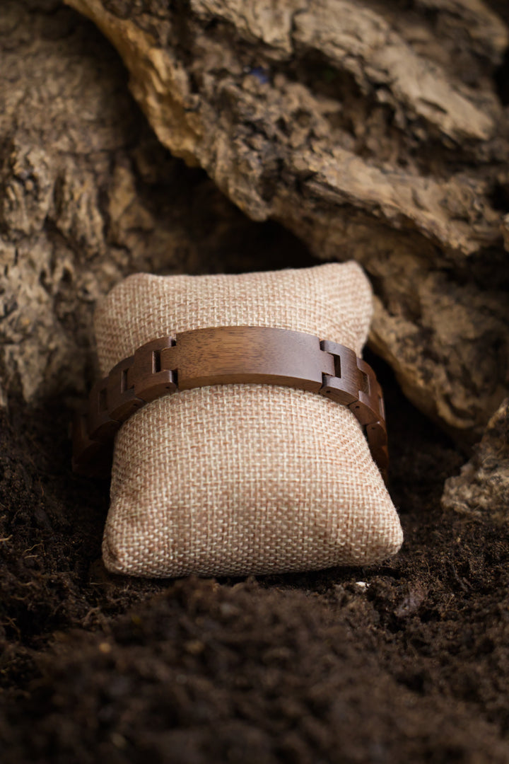 Juglans walnut wooden bracelet on a hessian cushion - The Wood Look