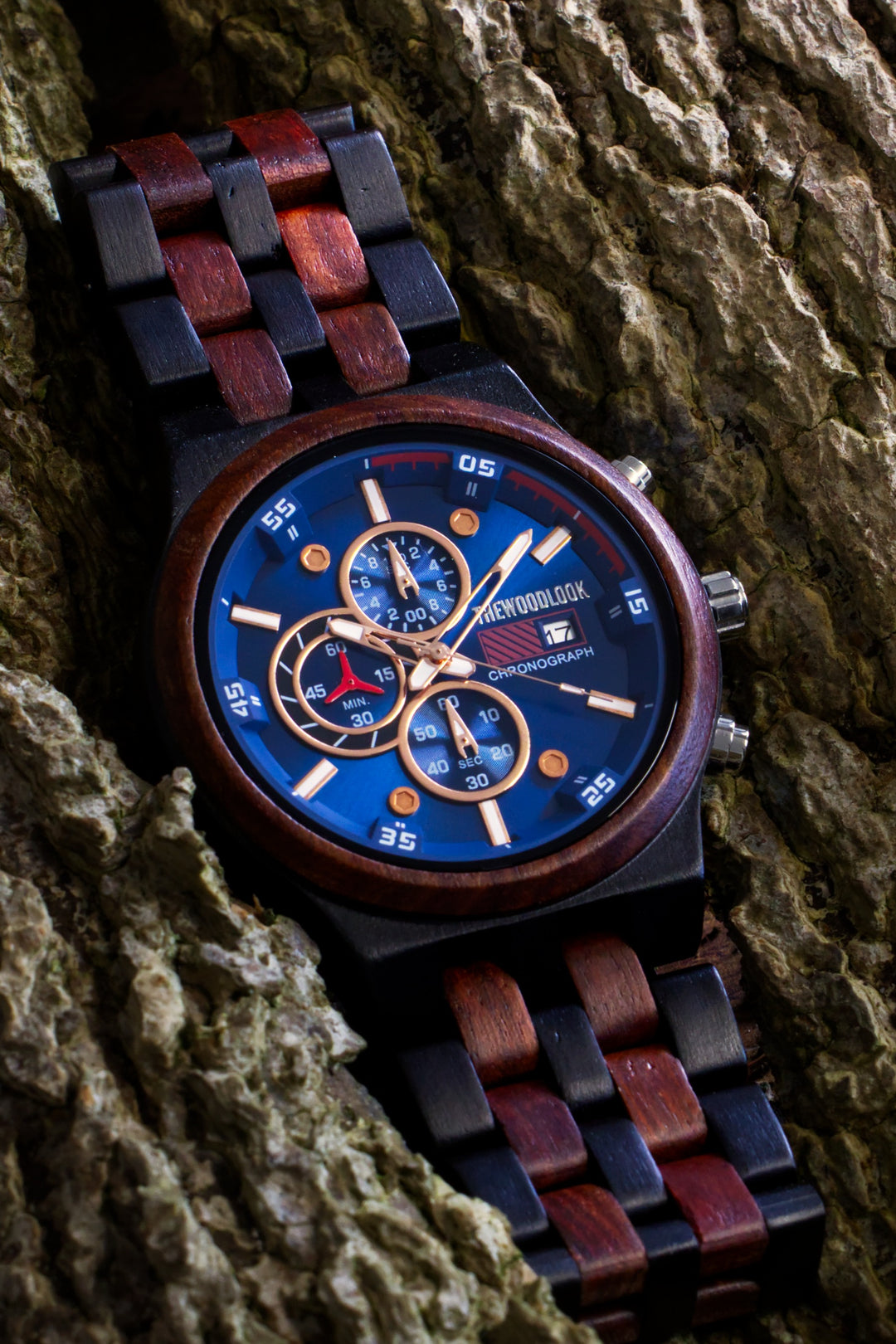 Lisbon chronograph watch with a blue dial and red sandalwood and ebony bracelet on tree bark - The Wood Look