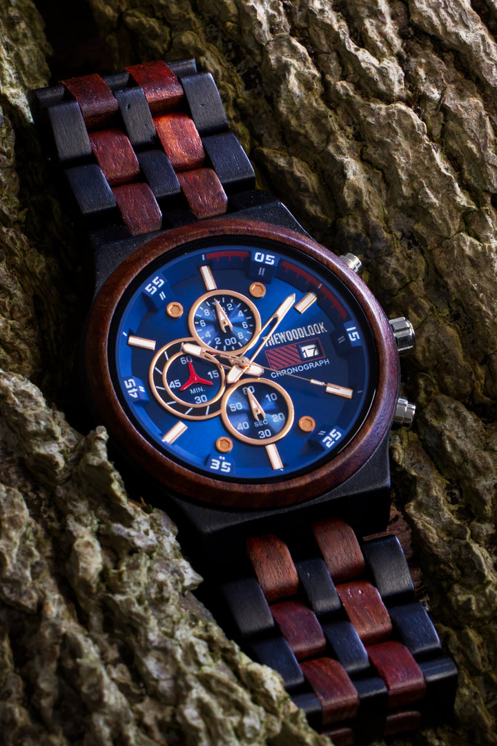 Lisbon chronograph watch with a blue dial and red sandalwood and ebony bracelet on tree bark - The Wood Look