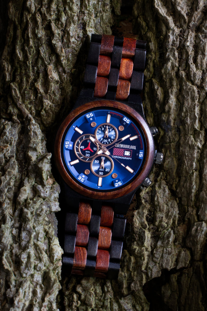 Lisbon red sandalwood and ebony wooden watch with its two-tone bracelet laid on bark - The Wood Look