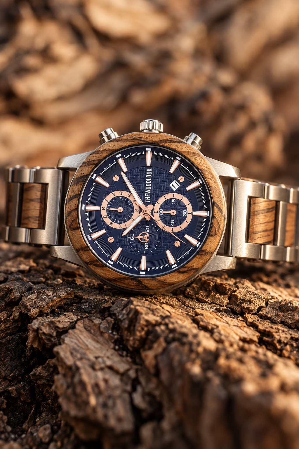 London zebrawood and silver chronograph watch with a navy dial on tree bark