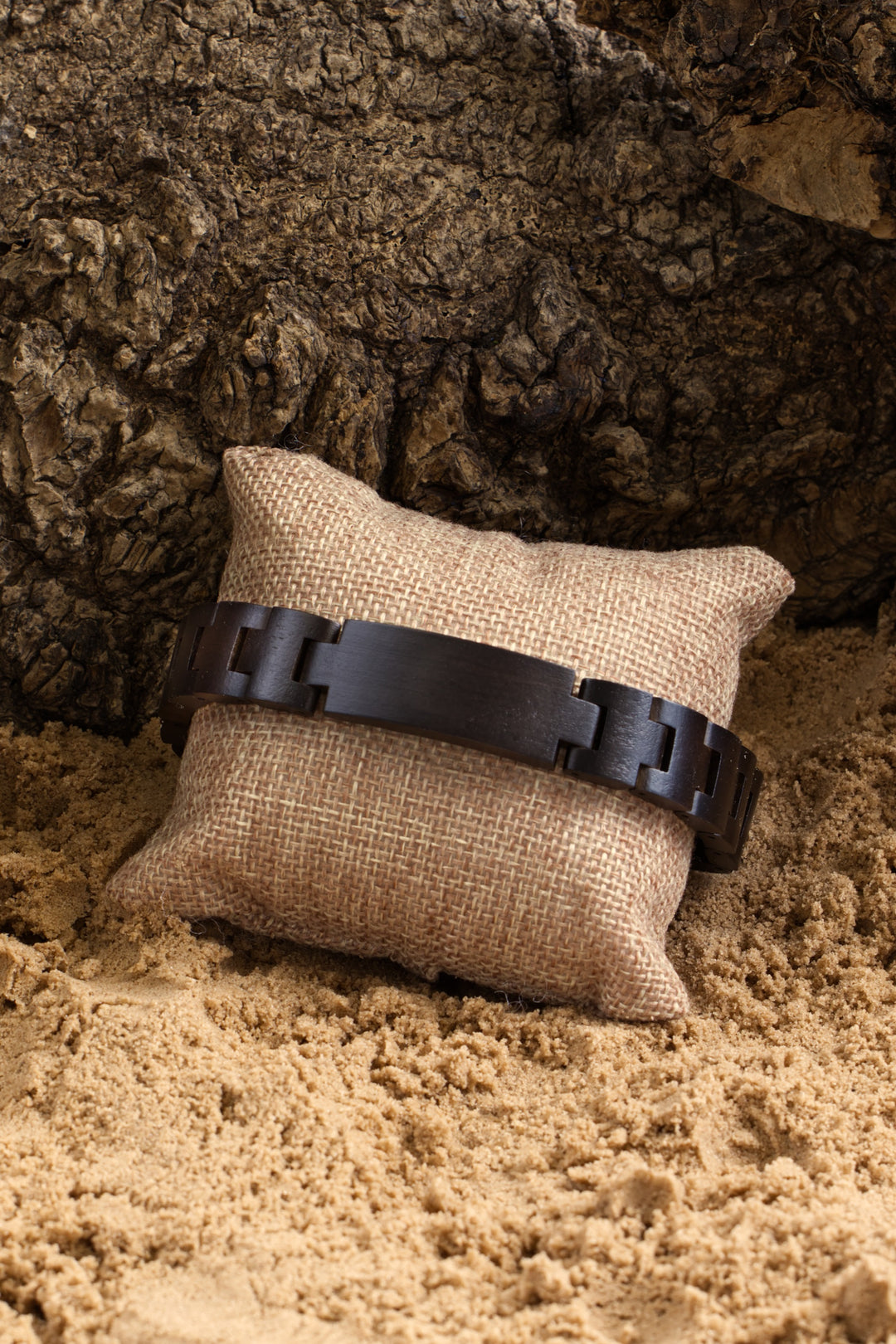 Nile ebony wooden bracelet on a hessian cushion in sand - The Wood Look