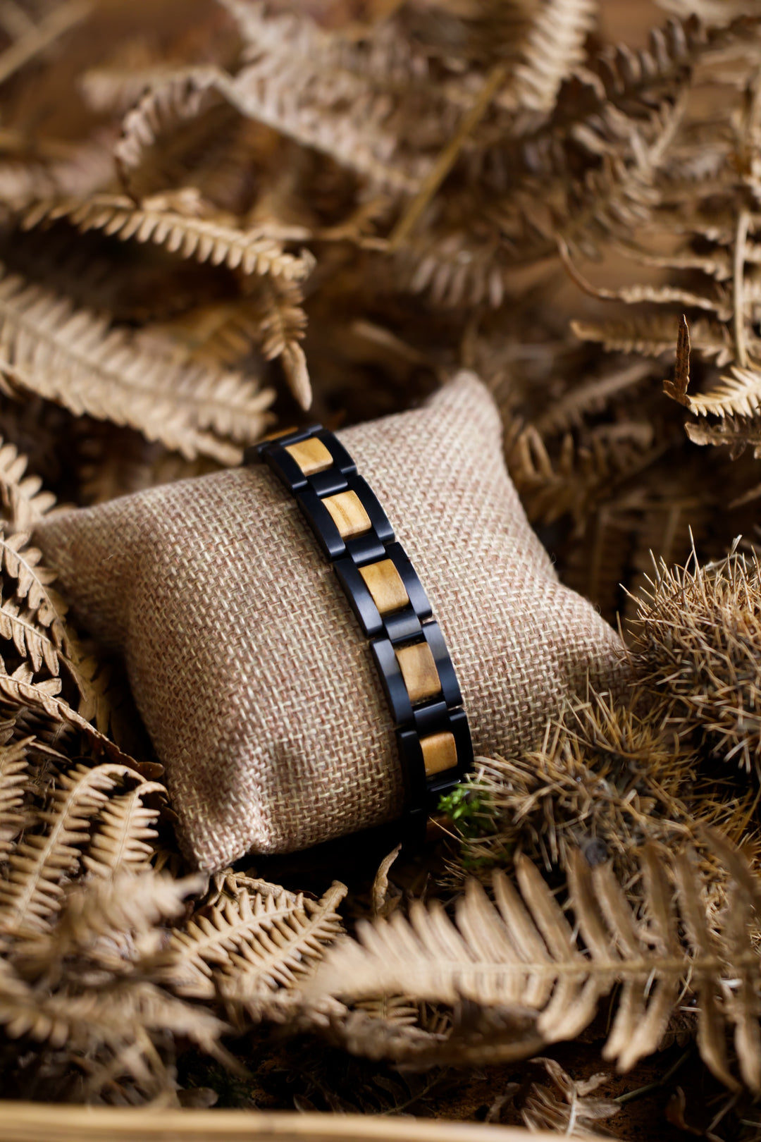 Paracas olive wood and brushed black steel bracelet on a cushion - The Wood Look