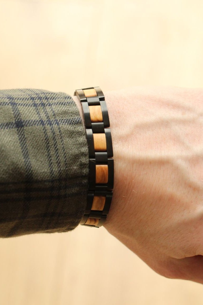 Paracas olive wood and black steel bracelet worn on the wrist with a check shirt - The Wood Look