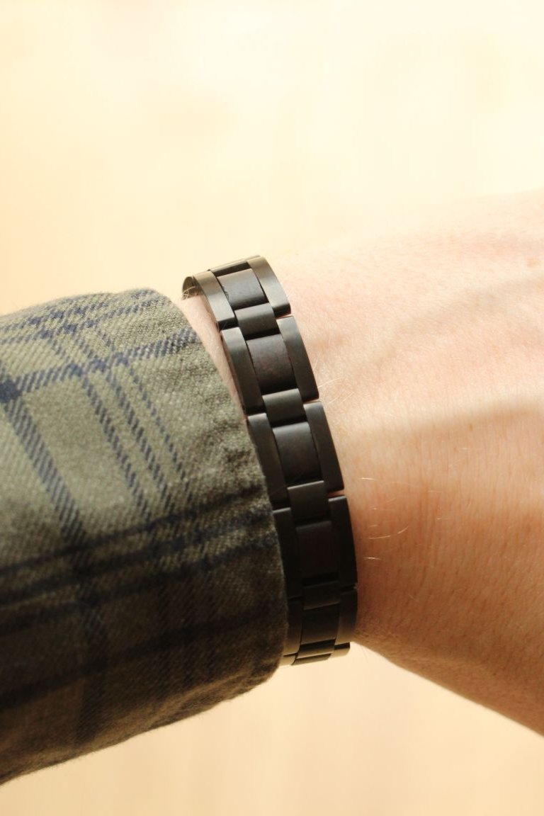 Reykjavik ebony and gunmetal steel bracelet worn on the wrist with a check shirt - The Wood Look