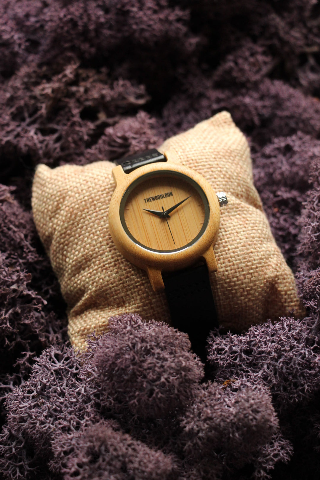 Sydney bamboo wooden watch with a bamboo dial and black strap on a cushion - The Wood Look