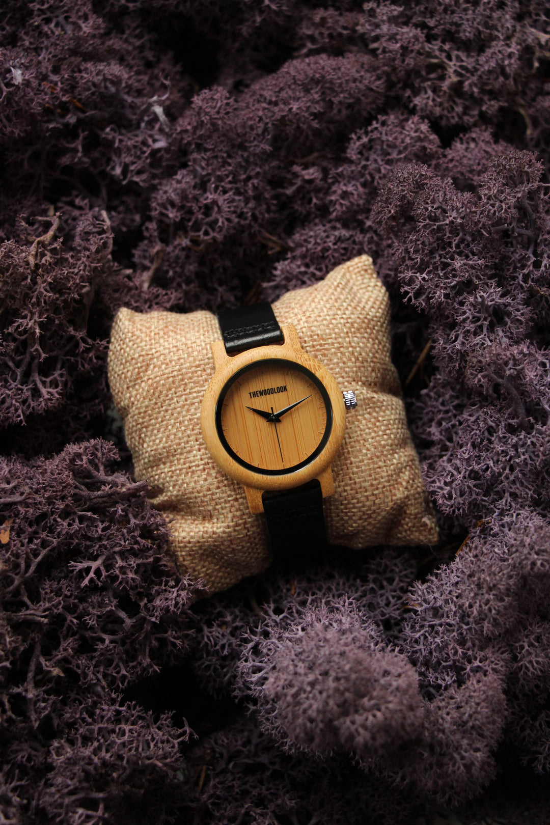 Sydney bamboo wooden watch on a small cushion surrounded by moss - The Wood Look