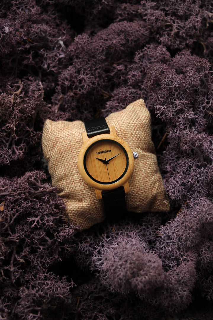 Sydney bamboo wooden watch on a small cushion surrounded by moss - The Wood Look