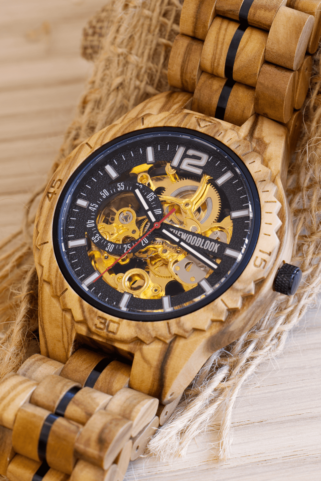 Close-up of the Venice olive wood watch showing the gold-tone automatic movement - The Wood Look